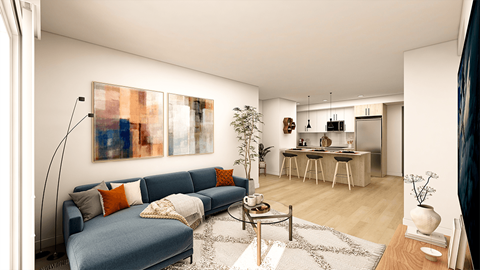 a living room with a blue couch and a kitchen with a bar